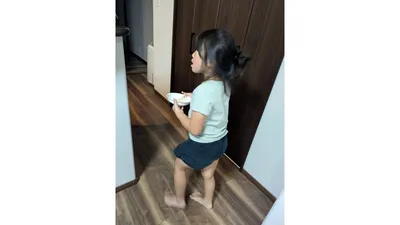 きょうだいそれぞれが、自分の使った食器を持ってキッチンへ向かうところ